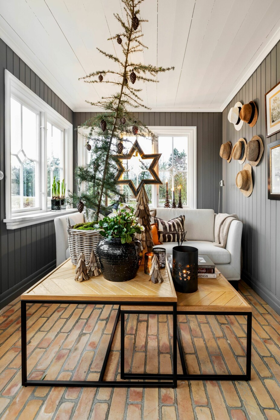 Also on the cozy glazed balcony, it is decorated for Christmas with a pine tree in a basket with moss.  Hanging on the wall a set of straw hats reminding you that one day summer will return.  The furniture was designed by Halvor.