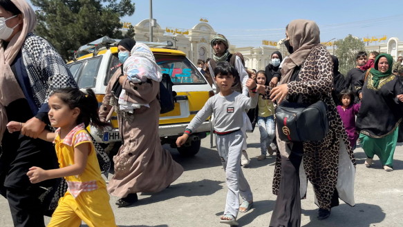 Women and children desperately tried to reach Kabul airport on Monday.