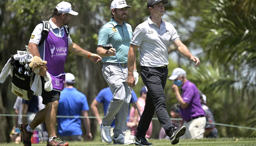 Playing partner: Victor Hovland (centre) plays Louis Oosthuizen (right) on Thursday.  Photo: AP Photo/Phelan M. Ebenhack