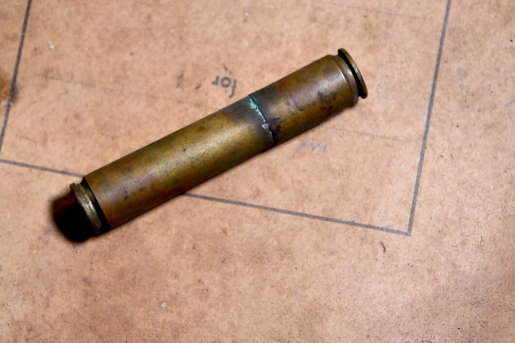 Two rifle cartridges were cut, probably from a Mauser, and assembled together.  why?  What is it used for?  Is there something hidden inside?