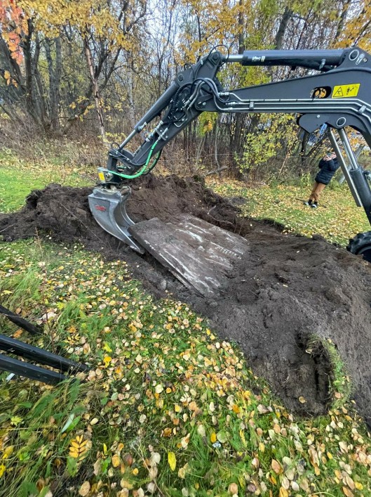 Daniel Valstad received help from a neighbor using an excavator.