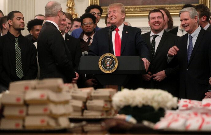 BON APPETIT #2: Two months later, Trump repeated his burger stunt, this time with members of the North Dakota State football team.  Photo: Jonathan Ernst/Reuters/NTP