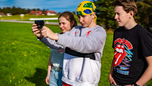 Youth: Vegard Roksvåg Baadnes investigates cultural relics using his mobile phone, while son Ermili Sorley and John Peder Cruz follow with excitement.
