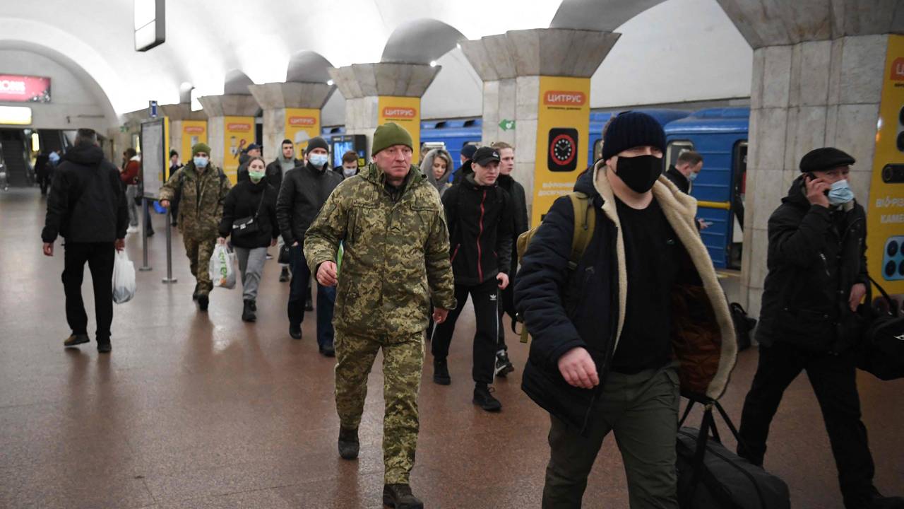 People carry suitcases and bags at a metro station in Kiev Thursday morning. 