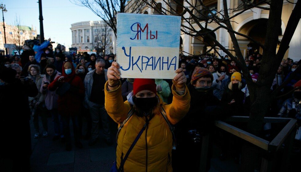 Large crowds: a woman holding a sign that reads 