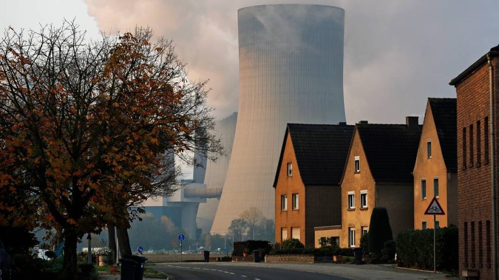 GERMANY/ Houses are pictured in front of the coal power plant of German utility RWE Power near Niederaussem
