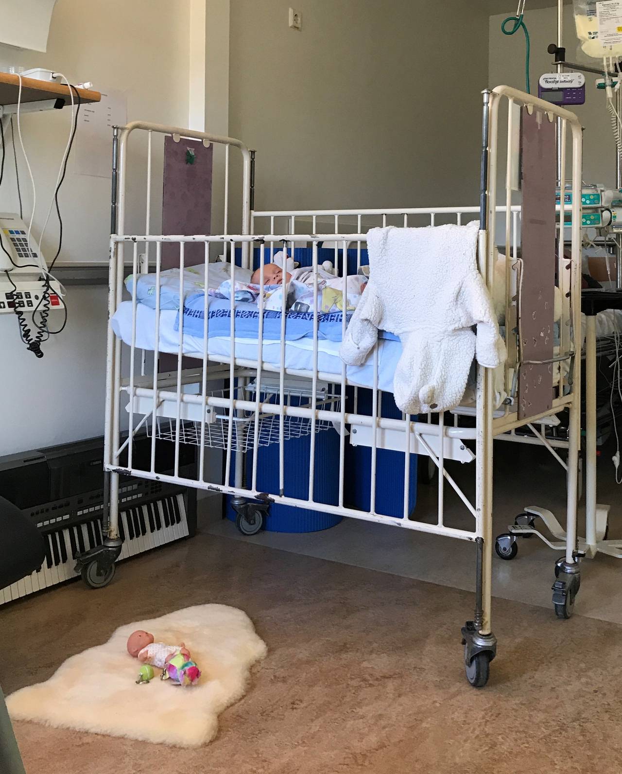 Sonia Victoria in her hospital bed.  The doll on the floor is the only thing that indicates that the room belongs to a child.